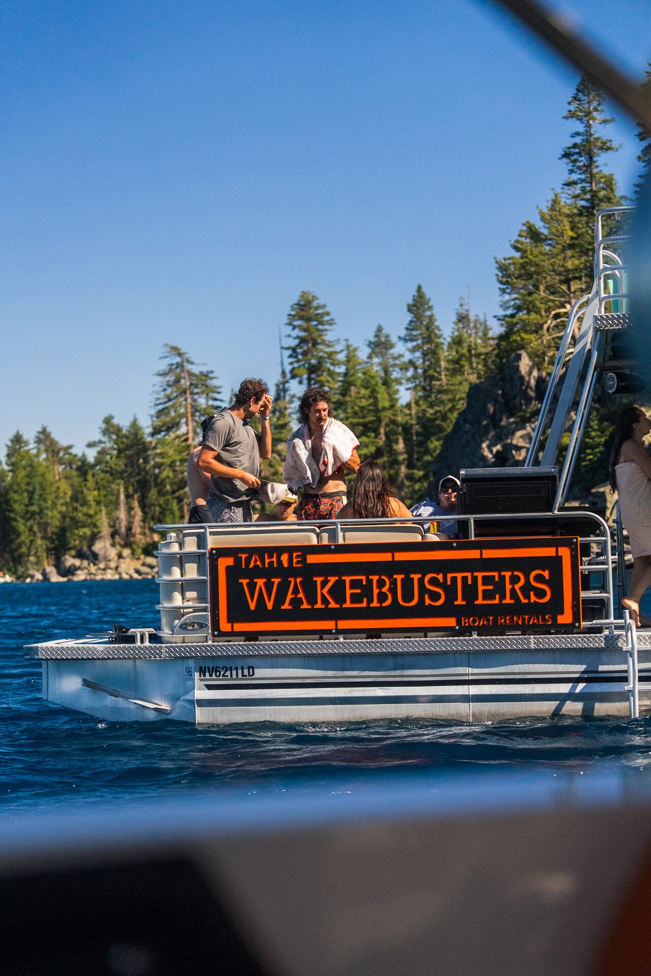 Guests tubing behind a Tahoe WakeBusters boat rental on Lake Tahoe